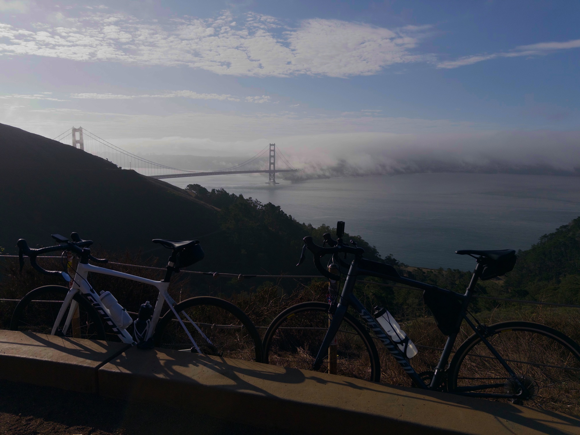 Road bikes overlooking the Golden Gate Bridge above the fog